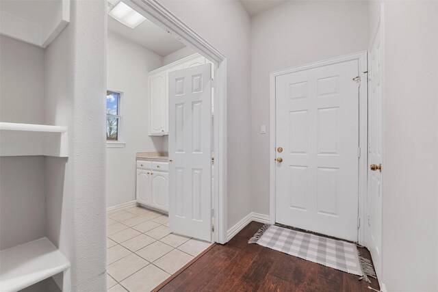 entrance foyer with baseboards and light wood-style floors