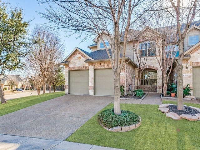 view of front of home with a shingled roof, an attached garage, driveway, brick siding, and a front yard