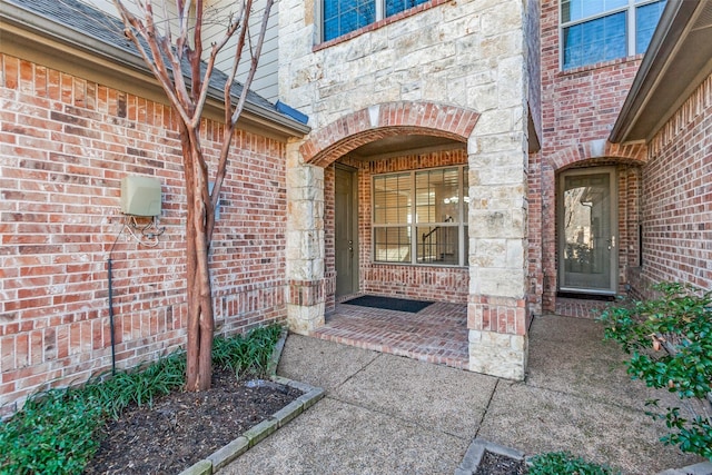 entrance to property with brick siding and stone siding