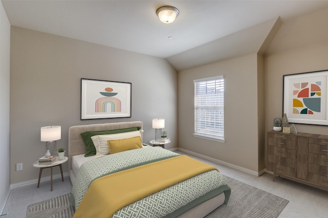bedroom with baseboards, vaulted ceiling, and carpet