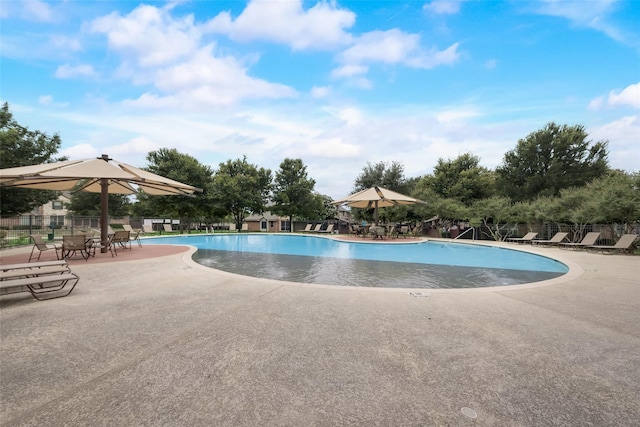 pool with fence and a patio