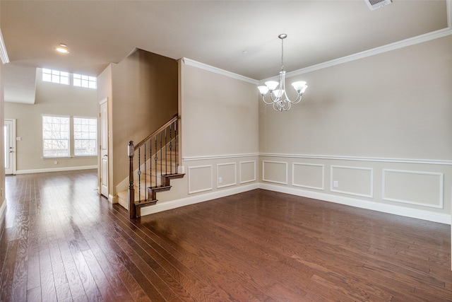 unfurnished room featuring a chandelier, crown molding, stairs, and dark wood-style floors