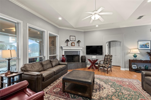 19407 Sara Ln, Flint, TX 75762 - living room featuring light wood-style flooring, a tiled fireplace, visible vents, lofted ceiling, and a ceiling fan