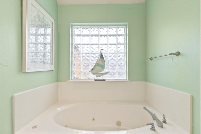 full bath with a jetted tub and a wealth of natural light