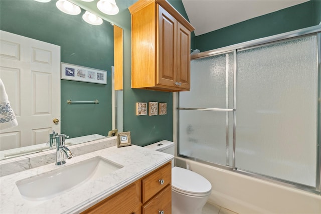 full bathroom with tile patterned flooring, enclosed tub / shower combo, vanity, and toilet