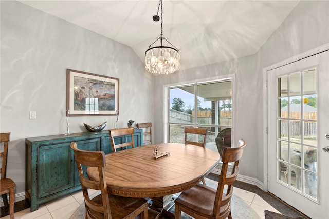 dining space with lofted ceiling, an inviting chandelier, baseboards, and light tile patterned flooring