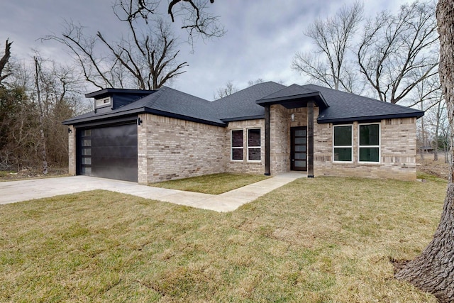 view of front facade with a shingled roof, a front yard, concrete driveway, and brick siding