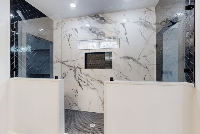 bathroom with a marble finish shower and recessed lighting