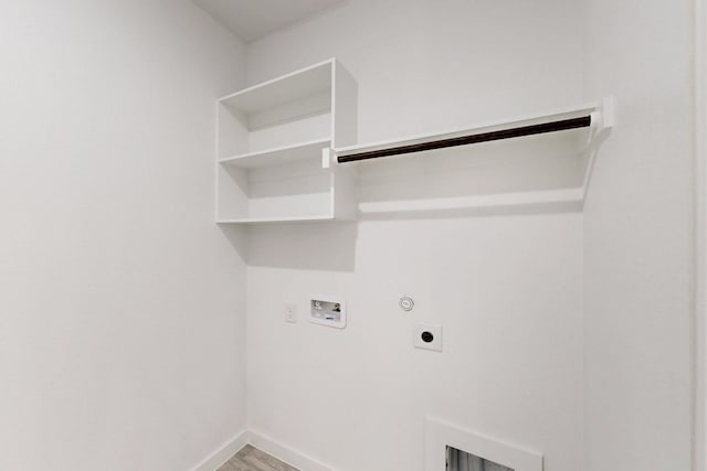 laundry room with washer hookup, light wood-style floors, gas dryer hookup, electric dryer hookup, and laundry area