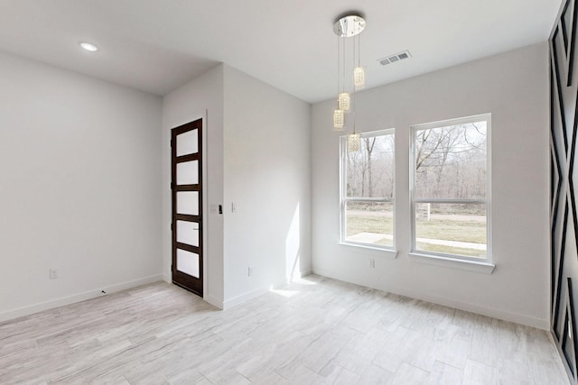 spare room with visible vents, plenty of natural light, and baseboards