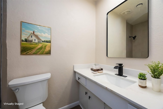 bathroom featuring toilet and vanity