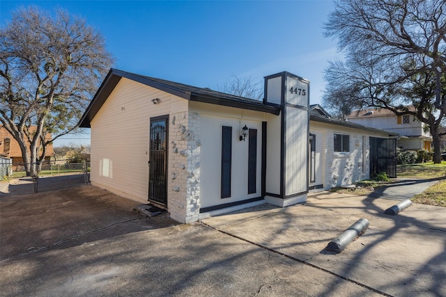 exterior space with a chimney and fence