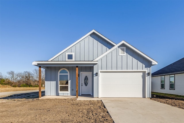 modern inspired farmhouse featuring a garage, concrete driveway, and board and batten siding