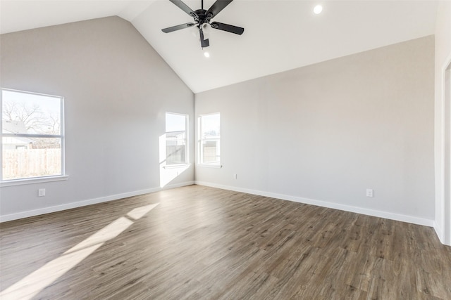 empty room featuring a wealth of natural light, ceiling fan, baseboards, and wood finished floors