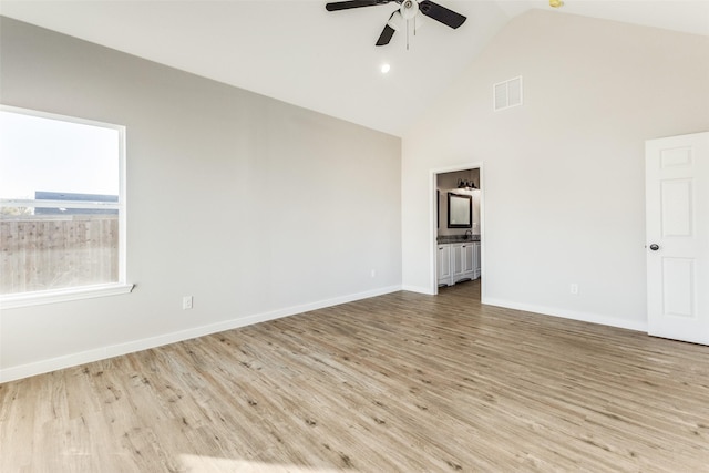 empty room with wood finished floors, visible vents, and baseboards