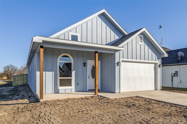 modern farmhouse featuring an attached garage, driveway, and board and batten siding