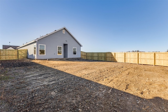 rear view of property with a fenced backyard