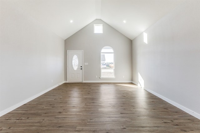 foyer featuring high vaulted ceiling, baseboards, and wood finished floors