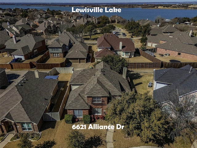 bird's eye view featuring a water view and a residential view