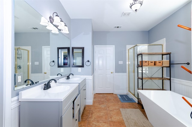 full bathroom featuring a wainscoted wall, visible vents, a sink, and a shower stall