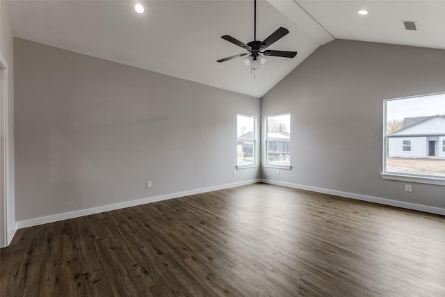 spare room with lofted ceiling, a ceiling fan, baseboards, and dark wood-type flooring