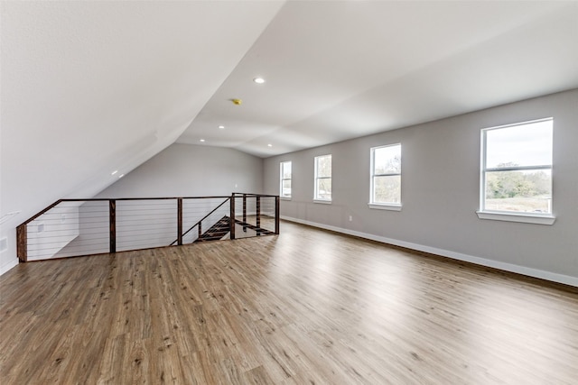 additional living space featuring vaulted ceiling, recessed lighting, wood finished floors, and baseboards