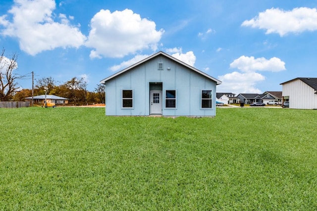 rear view of property featuring a yard