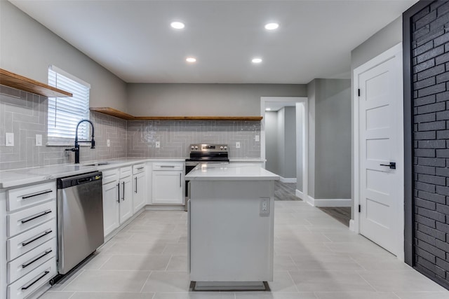 kitchen featuring a kitchen island, appliances with stainless steel finishes, open shelves, and a sink