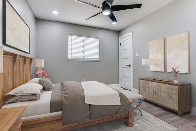 bedroom with recessed lighting, wood finished floors, a ceiling fan, and baseboards