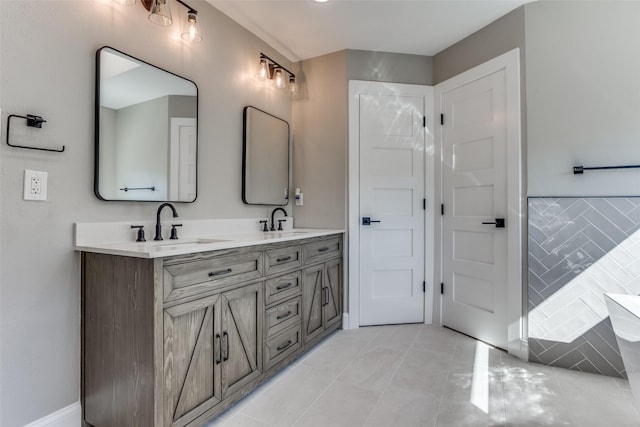 bathroom featuring tile patterned flooring, a sink, a bathing tub, and double vanity