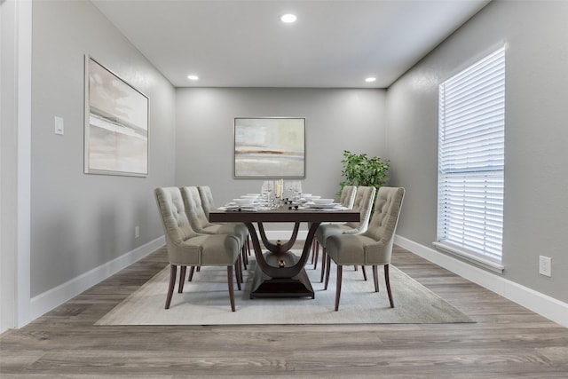 dining space with recessed lighting, baseboards, and wood finished floors