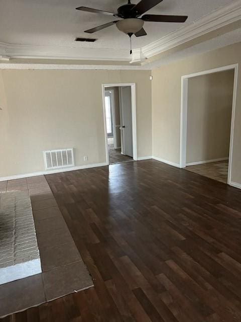 spare room featuring visible vents, crown molding, and wood finished floors