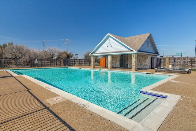 pool with an outbuilding, an exterior structure, a patio, and fence