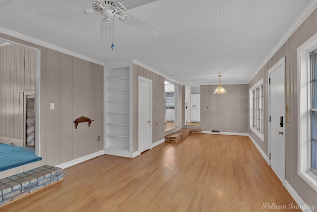 entrance foyer with ornamental molding, baseboards, and wood finished floors