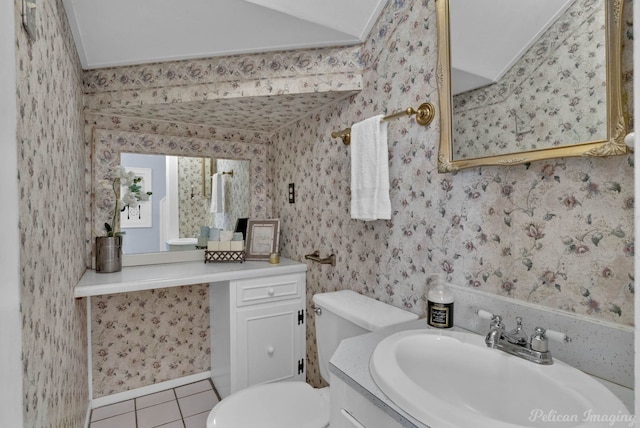 bathroom featuring vanity, tile patterned floors, toilet, and wallpapered walls