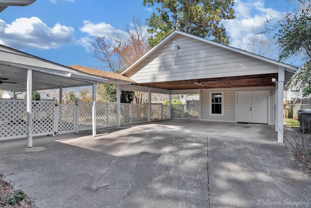 view of property exterior featuring a carport, fence, and driveway