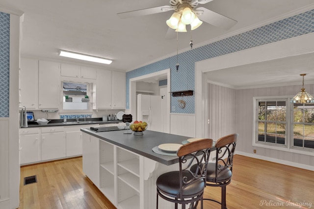 kitchen with open shelves, dark countertops, visible vents, white fridge with ice dispenser, and wallpapered walls