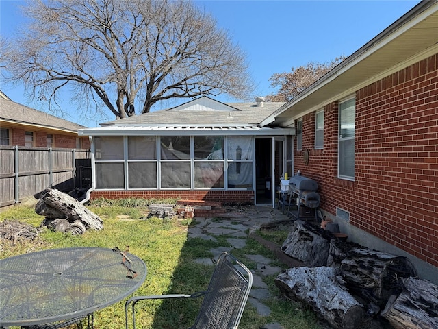 view of yard with a patio area, fence, and a sunroom