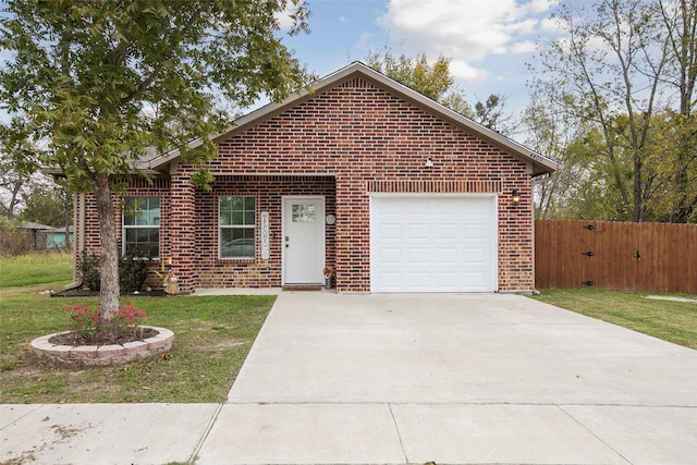 single story home featuring brick siding, an attached garage, fence, driveway, and a front lawn