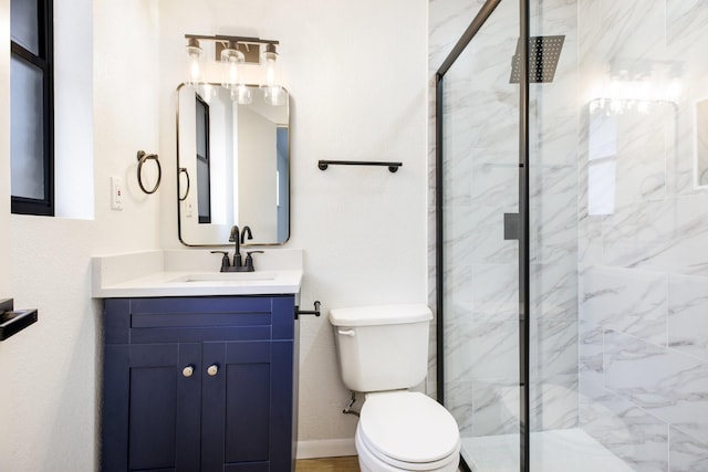 bathroom featuring vanity, a marble finish shower, toilet, and baseboards