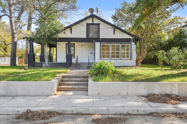 bungalow with a porch and a front yard