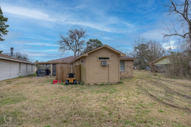 back of property with brick siding and a yard