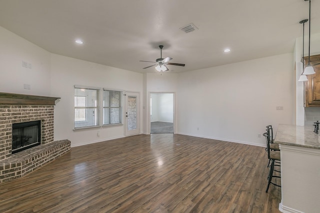 unfurnished living room with recessed lighting, dark wood-style flooring, a fireplace, visible vents, and a ceiling fan