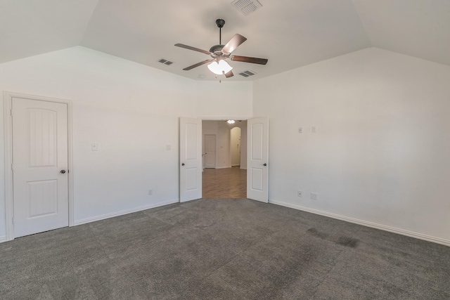 unfurnished room with carpet, visible vents, vaulted ceiling, and a ceiling fan