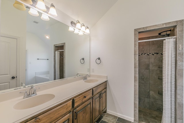 full bathroom with lofted ceiling, a sink, and a tile shower