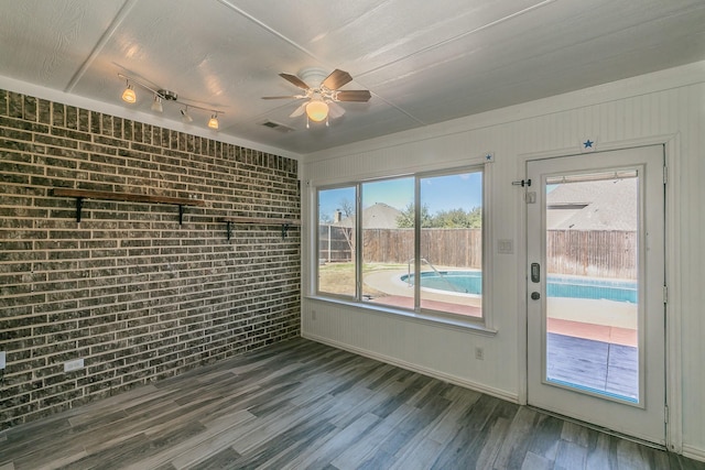 unfurnished sunroom featuring a ceiling fan and visible vents