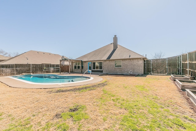 view of swimming pool featuring a fenced in pool, a fenced backyard, a vegetable garden, and a lawn