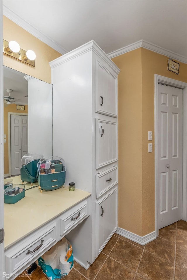 mudroom with crown molding and baseboards