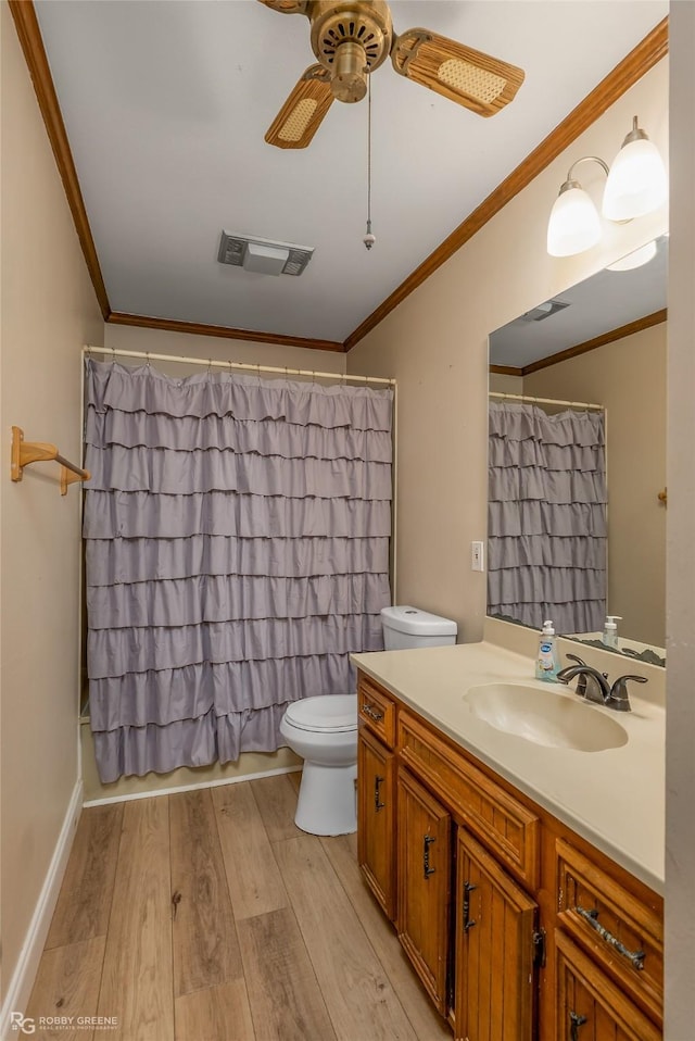 bathroom featuring ornamental molding, visible vents, toilet, and wood finished floors