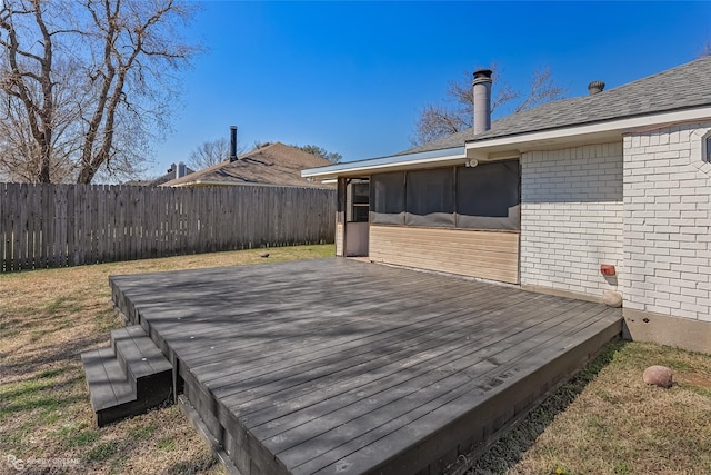 wooden deck with a yard, a fenced backyard, and a sunroom